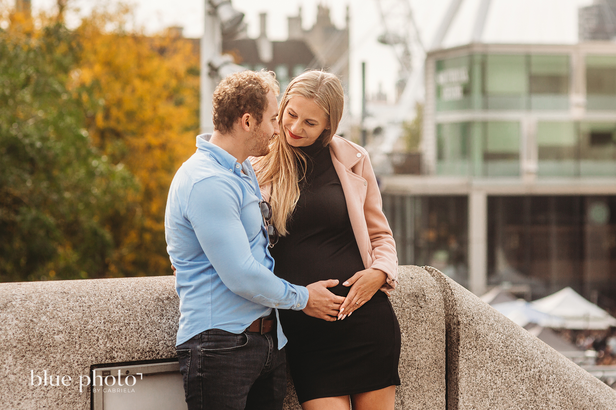 Angelika and Wojtek during their maternity session in South Bank, Central London. The couple is looking at each other and smiling. 